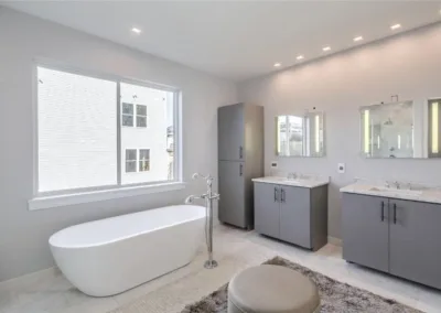 A white bathroom with a tub and sink.