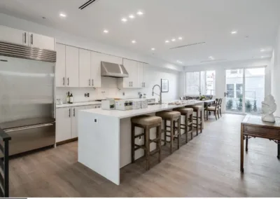 A kitchen with white cabinets and stainless steel appliances.