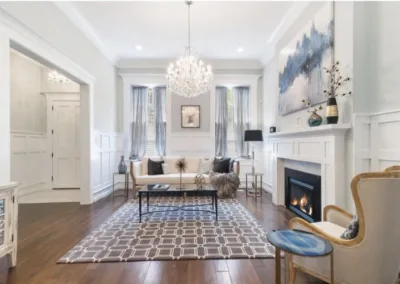 A living room with hardwood floors and a fireplace.